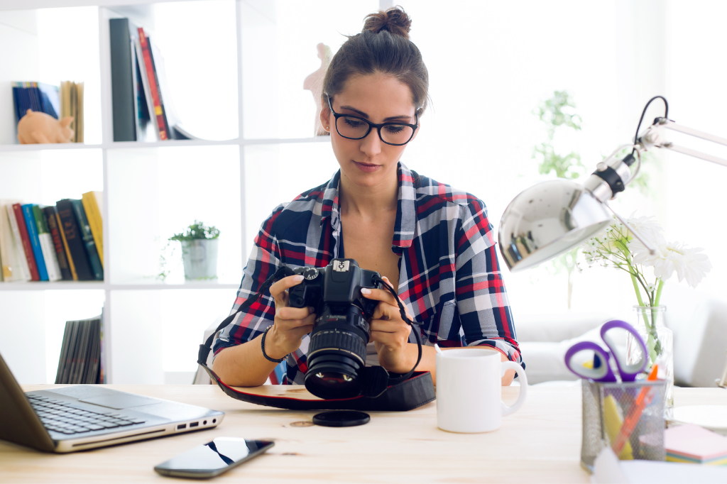 Female roofer looking at pictures and uploading them to her website