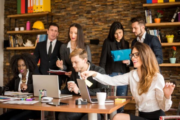 A well-dressed marketing team gathers around a table