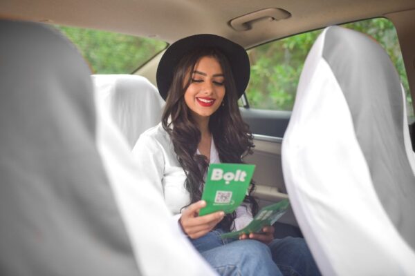 a woman reading a roofing flyer in a car